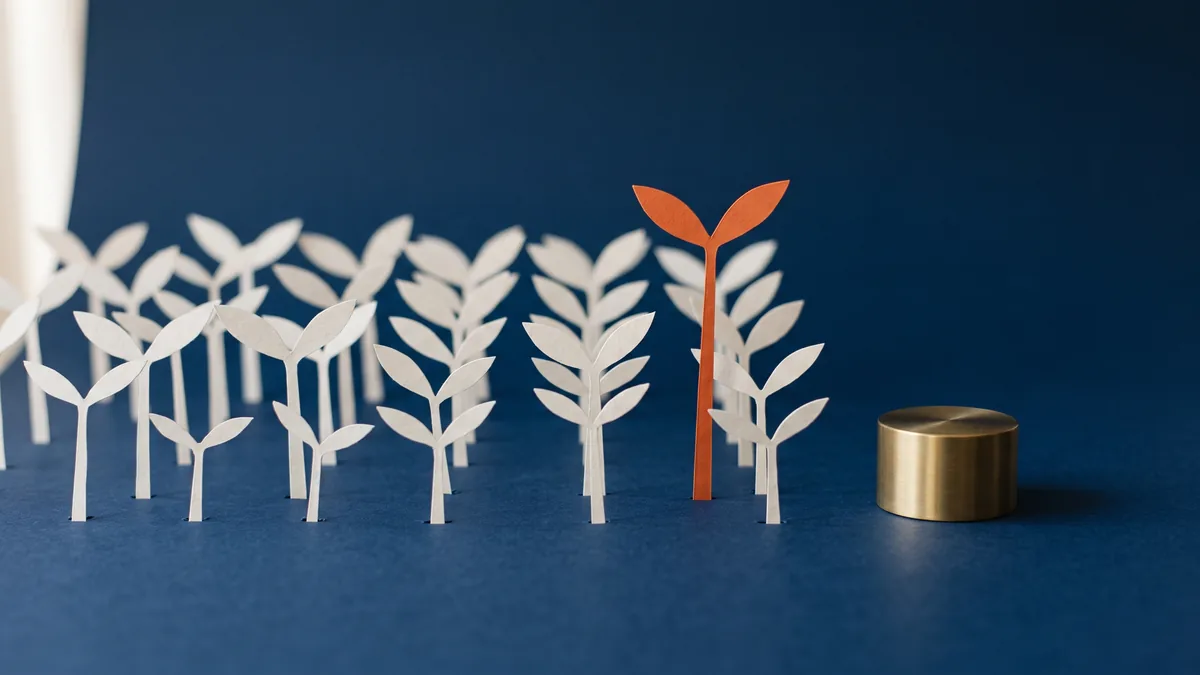 Rows of paper sprouts at different heights, the tallest in orange, the cover image for AI Adoption (May 2026 Update)