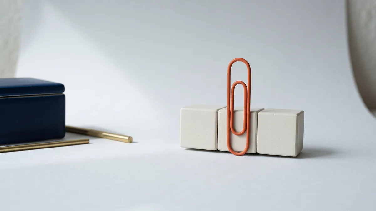 Row of server blocks held by an oversized orange paper clip, the cover image for Now Available: Clip Share Web Hosting
