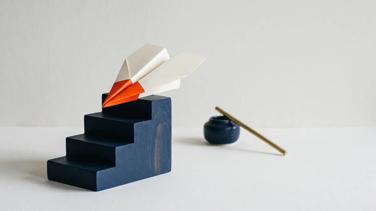 Paper airplane resting on the top step of a staircase model, the cover image for How to Rank #1 in Google: Matt Cutts