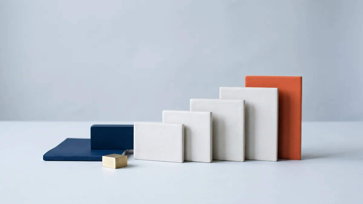 Six ceramic tiles rising as steps, the highest in orange, the cover image for Six Ways to Improve Your Site’s Google Search Optimisation