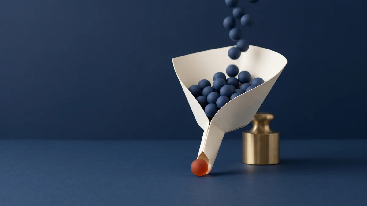 Paper funnel with navy spheres going in and one orange sphere coming out, the cover image for The Definitive Guide to Conversion Rate Optimization