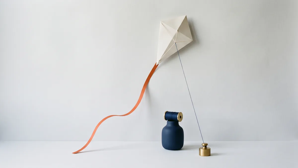 Paper kite with a long orange tail, the cover image for The Importance of Jumping on Buzzwords