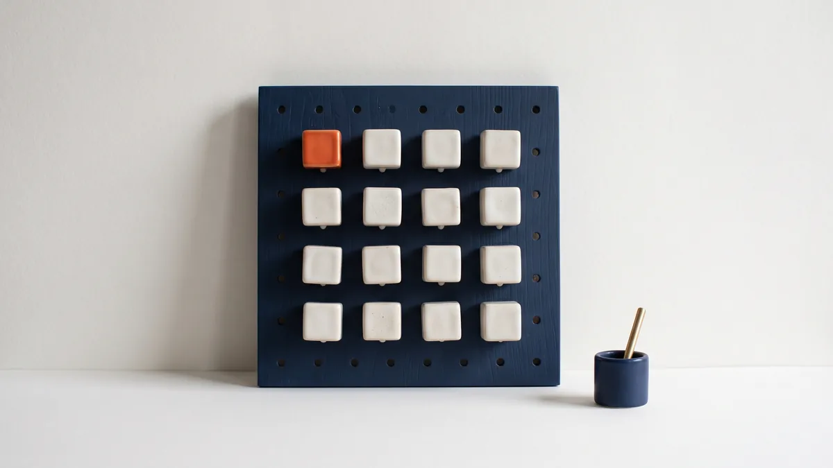 Twelve ceramic modules on a pegboard, one in orange, the cover image for Top 12 WordPress Plugins for SEO